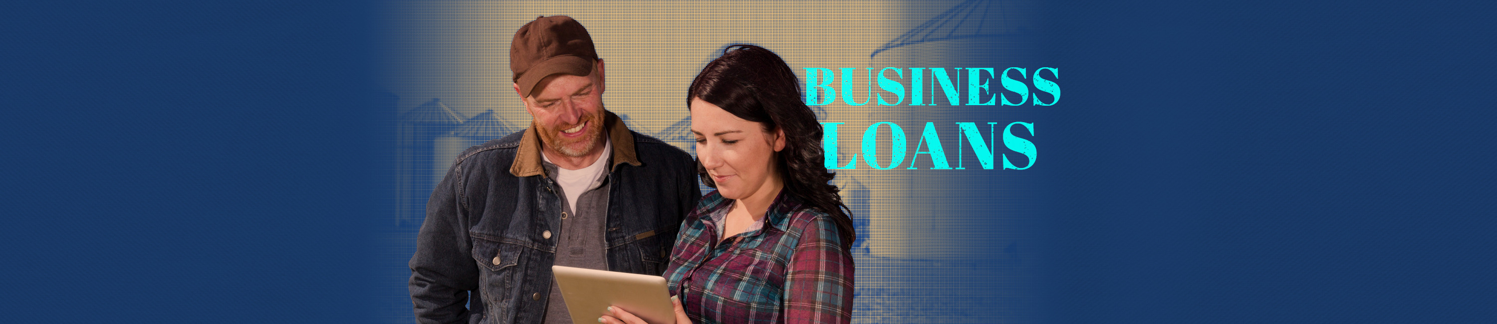 man and woman working together on her loan application with Fidelity Bank & Trust. Words on photo say Business Loans